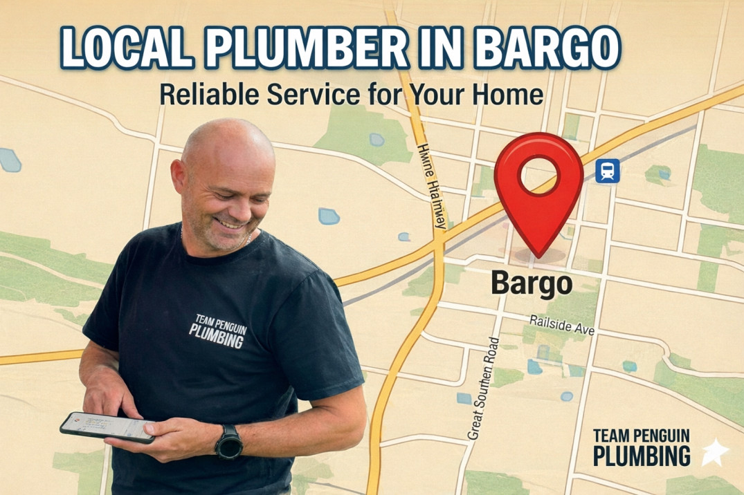 A smiling man in a Team Penguin Plumbing shirt holds a tablet in front of a map with a red location pin on Bargo. Text reads: Local Plumber in Bargo. Reliable Service for Your Home.